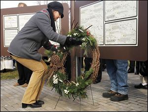 Alma Moore-Egen, a descendant of the Navarre family, lays a wreath at the battlefield's visitor center. About 30 members of the Navarre family fought in the battles.