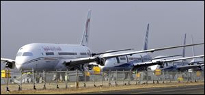 A line of 787 jets are parked at Paine Field in Everett, Wash. The battery that caught fire in a Japan Airlines Boeing 787 in Boston earlier this month was not overcharged, but government investigators said there could still be problems with wiring or other charging components.