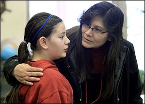 Maegan Pete, 11, is consoled by her mother, Tracie Pete, after she misspelled a word several rounds into the sixth-grade spelling bee at Bedford Junior High School. It lasted more than a dozen rounds.