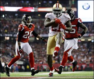 San Francisco 49ers running back Frank Gore breaks away for a nine-yard touchdown run during the second half of the NFC championship game against the Falcons on Sunday in Atlanta. Gore ran 21 times for 90 yards and two scores as the 49ers won 28-24, advancing to their first Super Bowl since January, 1995.