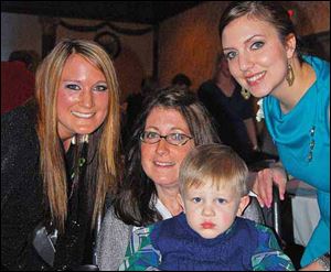 Committee members Megan Martinek, left, and Bethanie Cherry, right, pose for a photo with Melissa Belcher and her son Aden at the Miracles 4 Melissa Fund-raiser. The event raised money for Mrs. Belcher who is in the mid to late stages of Lou Gehrig’s disease.