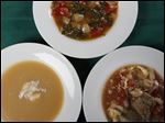  Soups clockwise from left, are roasted acorn squash and apple cider soup with creme fraiche, spinach and tomato soup and cabbage soup.