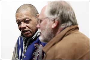 Mike Hampton, who has been out of prison for six years, left, speaks with volunteer Tom McCarter, right, during a monthly meeting at Government Center for the Re-Entry Coalition of Northwest Ohio, a group that lets those just released from prison know what social services are available to them to keep them from re-offending.