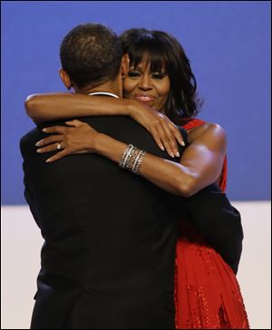 First lady Michelle Obama wraps her arms around President Barack Obama while dancing during the Inaugural Ball at the 57th Presidential Inauguration.