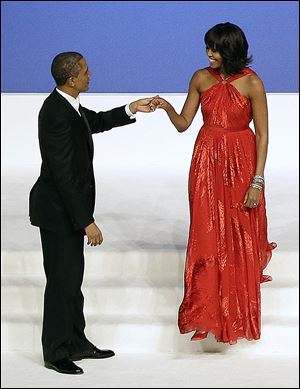President Obama greets the First Lady as she arrives on stage during the Commander-In-Chief Inaugural Ball at the Walter E. Washington Convention Center. 