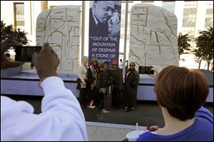 People pause for a picture with the Martin Luther King, Jr., float that is to appear in the 57th Presidential Inaugural Parade in Washington.