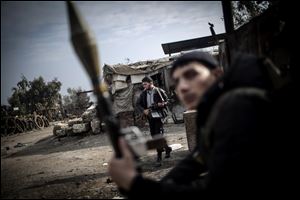 Free Syrian Army fighters hold their weapons during heavy clashes with government forces in Aleppo, Syria, Sunday.