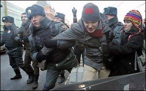 Police officers detain gay right activists during a protest near the State Duma, Russia's lower house of parliament, in Moscow, Russia, in December.