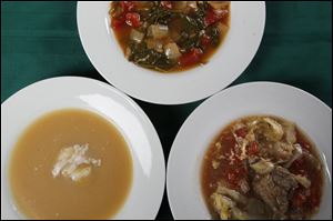 Soups clockwise from left, are roasted acorn squash and apple cider soup with creme fraiche, spinach and tomato soup and cabbage soup.