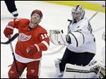  The Red Wings’ Daniel Cleary, left, reacts after getting hit with the puck in front of Stars goalie Kari Lehtonen, who made 39 saves to help spoil Detroit’s home opener Tuesday night.