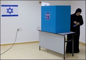 An Arab Israeli woman casts her vote during legislative elections today in the town of Tira, central Israel.
