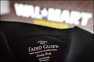 The label of a garment made in Bangladesh is displayed outside the Wal-Mart store where it's sold, in Atlanta. Wal-Mart Stores Inc. is alerting its global suppliers that it will immediately drop them if they subcontract their work to factories that haven't been authorized by the discounter.