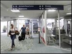  Passengers trickle out of the gate after landing from an American Eagle flight from Chicago to Toledo  Express Airport on June 28, 2012.
