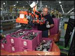  United Auto Workers assemblyman Len Rosenberger loads transmission kits at Ford's Van Dyke Transmission Plant in Sterling Heights, Mich., Thursday, Aug. 2, 2012. Ford says it's investing $220 million in the transmission plant to make the new hybrid-electric transmission. The new transmission is the first designed and produced entirely be Ford, which used to get its hybrid transmissions from a Japanese supplier. (AP Photo/Carlos Osorio)