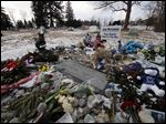  Momentos surround the headstone at the grave of former Penn State head football coach Joe Paterno as supporters of Paterno mark the 1-year anniversary of his death with a candlelight vigil Tuesday night. 