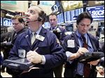  James Doherty, foreground left, works with fellow traders on the floor of the New York Stock Exchange Wednesday, Jan. 23, 2013. Stocks are opening mostly higher on Wall Street following strong earnings reports from Google, IBM and railroad operator CSX. (AP Photo/Richard Drew)