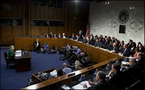 Secretary of State Hillary Clinton, left, testifies before the Senate Foreign Relations Committee hearing on the deadly September attack on the U.S. diplomatic mission in Benghazi, Libya.