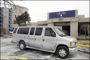 A shuttle van bears the vestiges of the former Hilton Toledo at the University of Toledo Medical Center. The campus lodging has been renamed The Hotel at UTMC after Hilton ended its affiliation.
