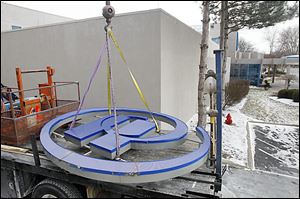 A Hilton logo sign is removed from The Hotel, formerly known as the Hilton.