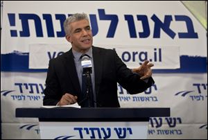 Yair Lapid gestures as he delivers a speech at  his 