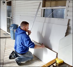 Volunteer Brandon Reynolds helps with drywall at You Lucky Dog in Oregon. Insurance helped pay for some of the damage caused by the storm, but not all.