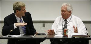 Board chairman Ron Rothenbuhler, right, and Republican board member Jon Stainbrook, left, said they learned about critical emails sent to the Secretary of State's office when they visited with officials in Columbus.