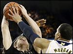  Jordan Morgan, right, blocks a shot by Purdue’s Travis Carroll during  Michigan’s win.