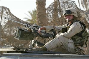 Aneta Urban sitting with a .50-cal. machine gun atop a Humvee in September 2003 while she was serving in the U.S. Marines with a military police company in Iraq.