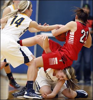 Archbold's Cassidy Williams, bottom, battles Wauseon's Alyssa Reed (21) for the ball during a game Thursday. Williams came off the bench to score a game-high 19 points for the Blue Streaks.