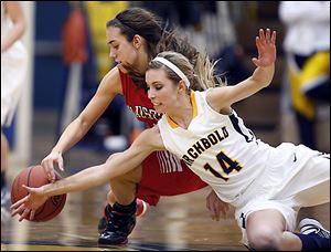 Archbold's Taylor Coressel (14) battles Wauseon's Haley Archibeque for  a loose ball during a basketball game Thursday.
