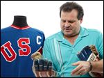  Former United States Olympic hockey player Michael Eruzione in Dallas with a jersey and the and gloves from his team's win against the Soviet Union hockey team at the 1980 Winter Olympics. 