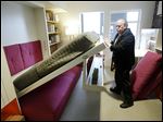  Jack Sproule tries out a fold-down bed in a 325 square foot model apartment at an exhibit called 