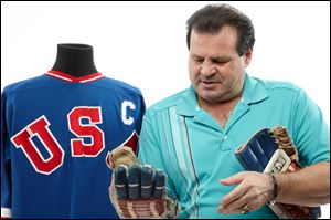 Former United States Olympic hockey player Michael Eruzione in Dallas with a jersey and the and gloves from his team's win against the Soviet Union hockey team at the 1980 Winter Olympics. 