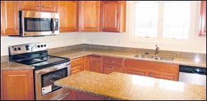 There is plenty of workspace in this lovely kitchen. Quality maple cabinets are topped with granite.