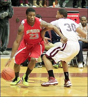 Bowsher's Nate Allen, left, drives past Scott's Bryson Collins. Allen scored a team-high 20 points for the Rebels, while Collins finished with 16 points and 10 rebounds.