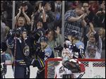  Toledo Walleye players Trevor Parkes, 8, Joey Martin, 14, and Andrej Nestrasil, 11, celebrate Parkes' goal against Bakersfield Condors goalie Brian Stewart.