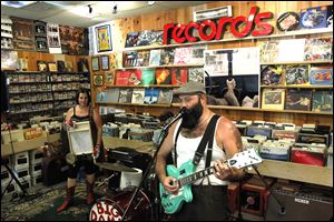 Reverend Peyton's Big Damn Band plays an in-store concert. Breezy Peyton, left, plays with Rev. Peyton, right.