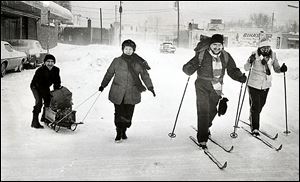 Lloyd, left, and Margaret Apling use a sled while Ray, second from right, and Mary O'Donnell use cross-country skis to go grocery shopping.