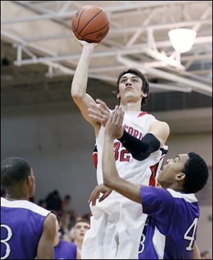Bedford's Jackson Lamb (32) takes a shot against Ann Arbor Pioneer's Tevis Robinson (43) during a basketball game Friday in Bedford, Mich.