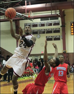 Jermul Richardson, shooting for two of his game-high 24 points in the second half. Defending is Bowsher's Josh Porter and Dajuan King, 13. 