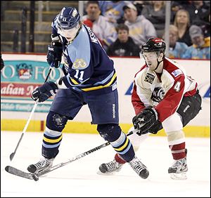 Andrej Nestrasil (11) battles with Bakersfield's Kyle Haines (4) for the puck during the second period.