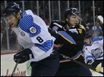  Evansville's TJ Miller is pushed aside by Toledo's Adam Hobson in the first period on Sunday. Miller played for the Walleye for three games earlier this month before being released.