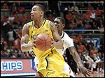  Michigan's Trey Burke, who had 19 points, drives past Illinois' Brandon Paul.