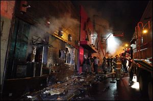 Firefighters work to douse a fire at the Kiss Club in Santa Maria city, Rio Grande do Sul state, Brazil, today.