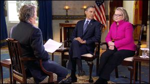 President Obama, center, and Secretary of State Hillary Rodham Clinton speak with 60 Minutes correspondent Steve Kroft, left, in the Blue Room of the White House in Washington. The interview aired Sunday during the 60 Minutes telecast on CBS.