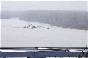 The towboat Nature Way Endeavor banks a barge against the western bank of the Mississippi River on Sunday. The river was closed to all traffic eight miles north and south of Vicksburg.