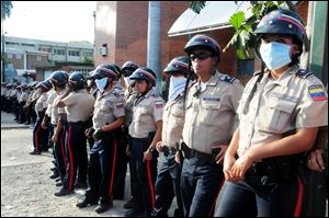 Venezuelan police officers stand guard outside the morgue where the bodies of prisoners killed in a riot were taken in Barquisimeto,Venezuela, Saturday.