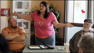Dawn Cornett was one of several who voiced frustration at what has been perceived as a lack of attention to Toledo’s east side as others listen during the meeting at Michael’s Cafe on Main Street.
