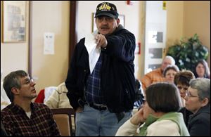 As others listen, Sam Tarsha defends new Toledo Councilman Shaun Enright, who held the meeting with two  colleagues.