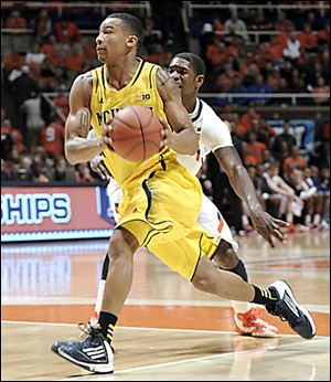 Michigan's Trey Burke, who had 19 points, drives past Illinois' Brandon Paul.